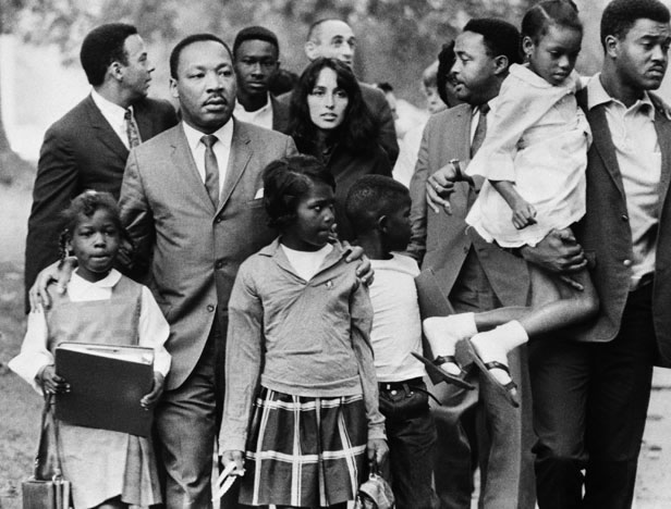 20 Sep 1966, Grenada, Mississippi, USA --- Dr. Martin Luther King is shown leading a group of black children to their newly integrated school in Grenada, Mississippi, escorted by folk singer Joan Baez and two aides, Andy Young (L) and Hosea Williams (next to Baez). --- Image by © Bettmann/CORBIS